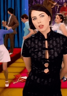 a woman in a black dress is standing on a stage in front of a crowd of people .