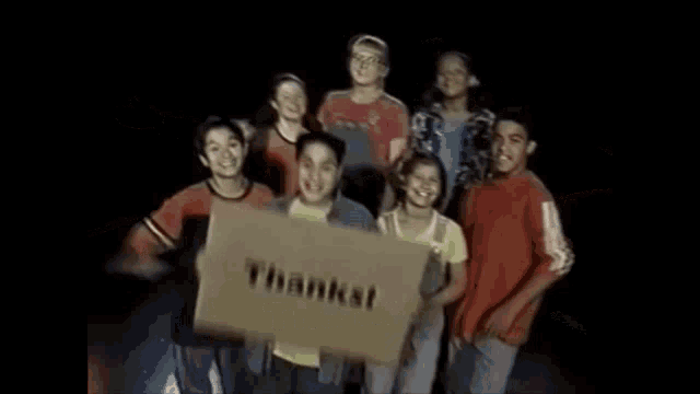a group of children are holding a cardboard box that says thanks .