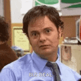 a man in a blue shirt and tie is saying `` big deal '' while sitting in an office .