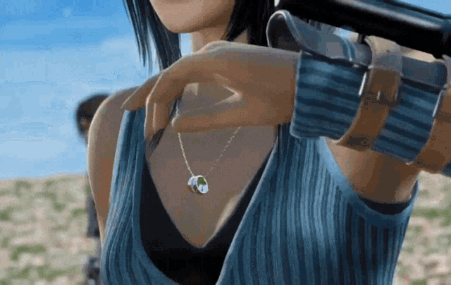 a woman in a blue shirt is holding a gun in her hand
