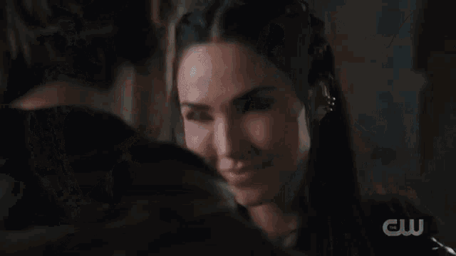 a man and a woman are looking into each other 's eyes in a close up .