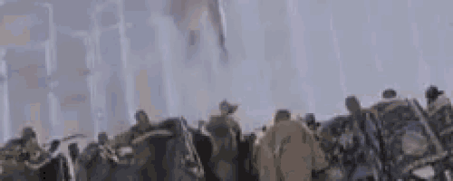 a black panther is standing in front of a crowd of people in a foggy forest .