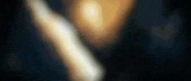 a blurry picture of a person 's face with a light shining on it