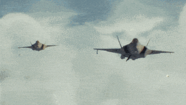 a fighter jet is flying over the ocean with smoke trails