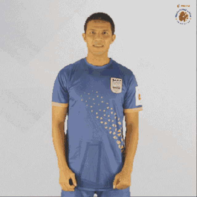 a man wearing a blue shirt with a logo on the front that says ' ambulance '