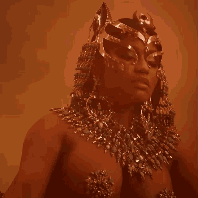a woman is wearing a crown and a necklace with rhinestones