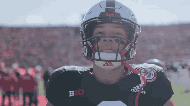 a football player wearing a helmet and a shirt that says big