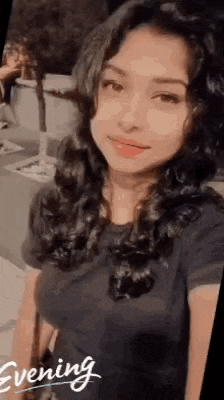 a woman with long hair is taking a selfie with her phone .