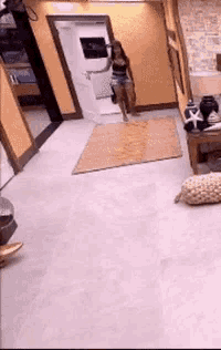 a woman is walking through a hallway in a living room .