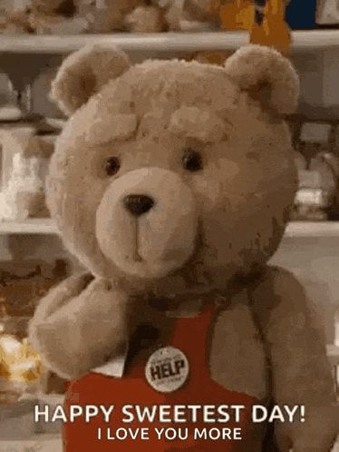 a teddy bear wearing a red apron with a help button on it is holding a box .