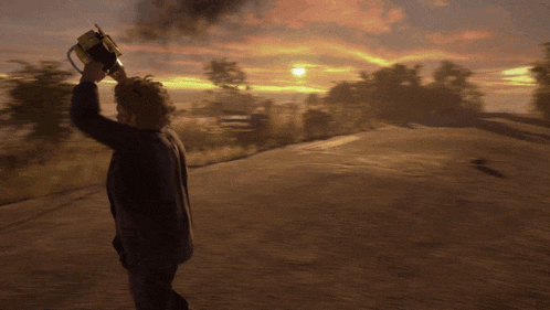a man is holding a chainsaw over his head while walking down a road