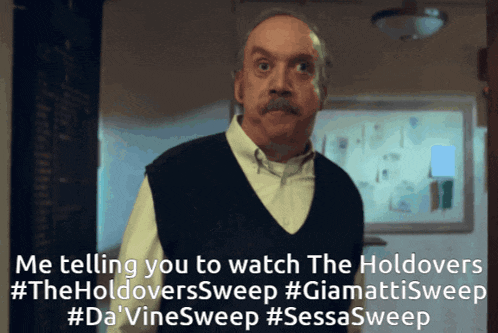 a man with a mustache is standing in front of a whiteboard with the words " me telling you to watch the holdovers " on it