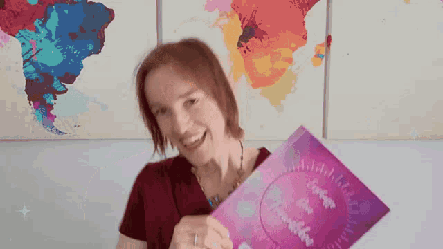 a woman in a red shirt is holding a purple book that says escape from travelers