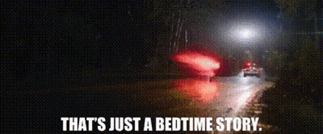a car is driving down a road at night with the words that 's just a bedtime story ..