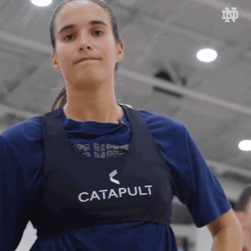 a woman is wearing a vest that says catapult