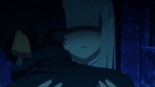 a man and a woman are hugging in the dark