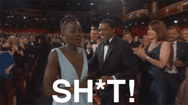 a woman in a white dress is standing in front of a crowd and says shit