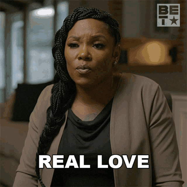 a woman says " real love " while wearing a jacket