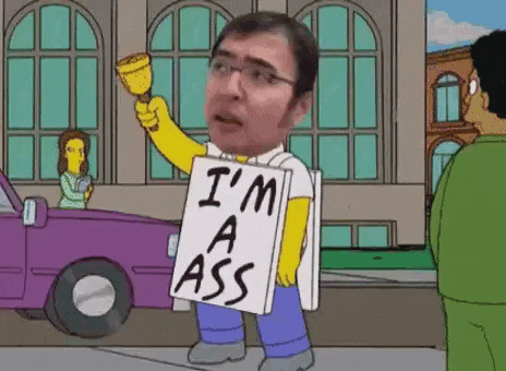 a man is holding a sign that says `` i 'm a ass '' .