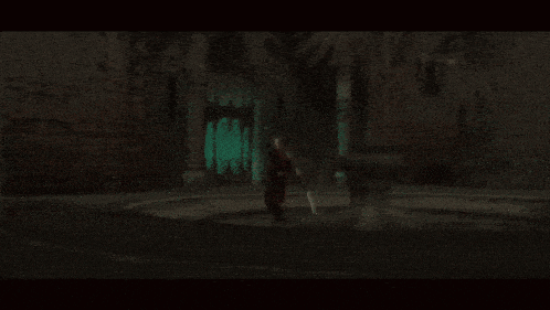 a person 's foot is visible in a dark room with red smoke coming out of it
