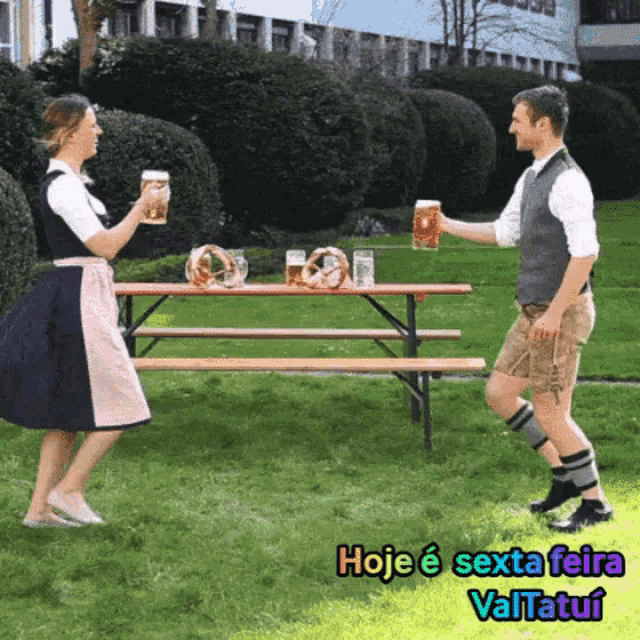 a man and woman toasting with beer mugs in front of a picnic table with pretzels on it