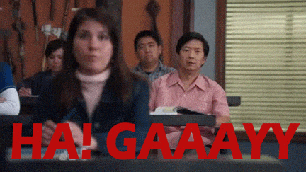 a group of people are sitting in a classroom with the words hai gaaayy in red