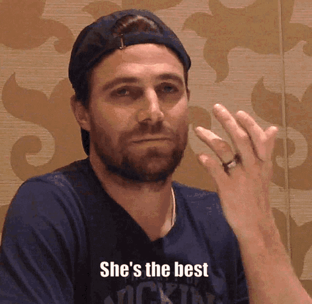 a man wearing a baseball cap and a ring says she 's the best