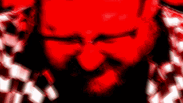 a man with a beard is making a face in a red background