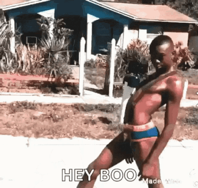 a woman in a bikini is dancing on the sidewalk in front of a house .
