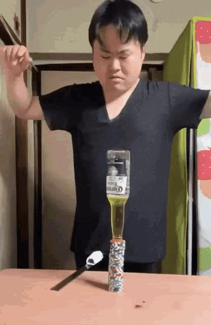 a man holding a bottle of corona beer