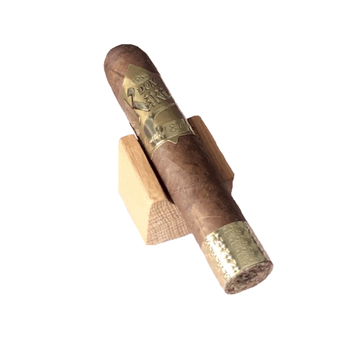 a cigar is sitting on a wooden block with a label that says ' toro '