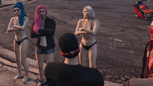 a group of women in bikinis standing next to a man in a black shirt