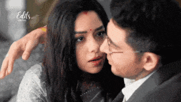 a man kissing a woman 's forehead with the words edits below