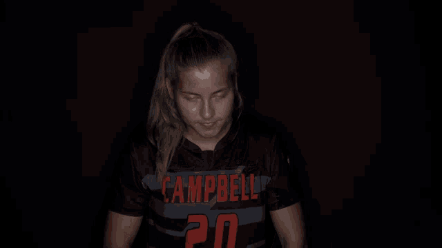 a girl wearing a campbell jersey smiles for the camera