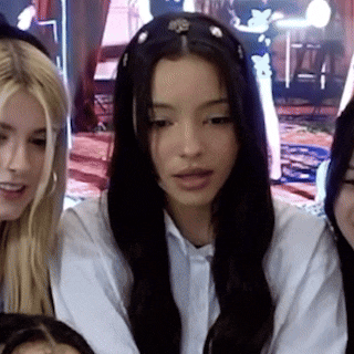 a girl with long black hair is wearing a headband with rhinestones on it