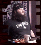a man with a beard wearing a shirt that says murphys