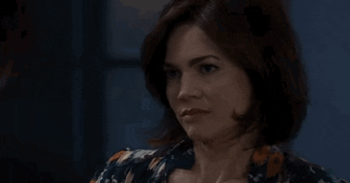 a close up of a woman 's face in a room .