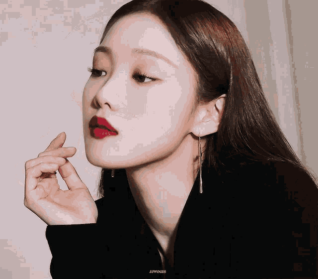 a close up of a woman 's face with the word jhong on the bottom left