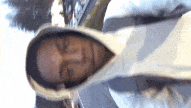 a man wearing a white hoodie with a hood