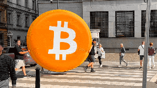a large orange coin with the letter b on it is being pulled by a man