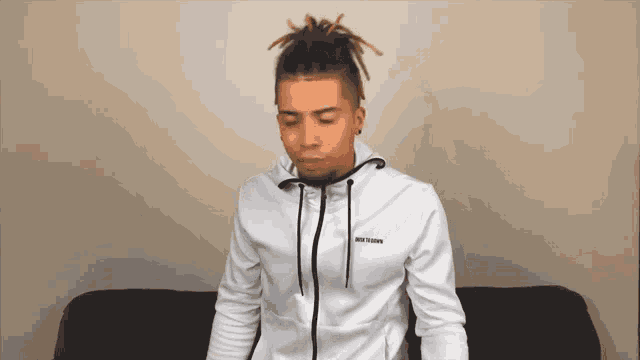 a man wearing a white jacket that says just do it