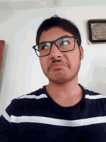 a young man wearing glasses and a striped shirt