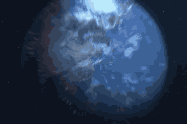 a blurry picture of a blue planet with a dark background