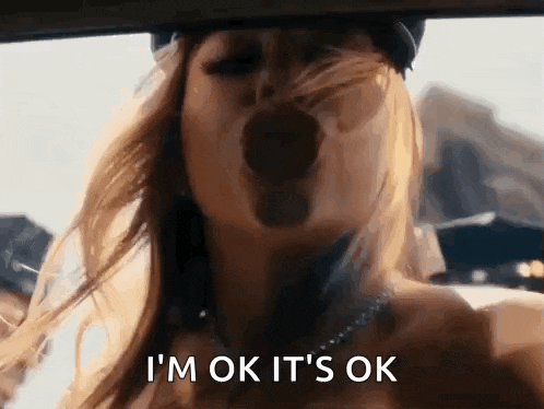 a woman is yawning in a car and saying i 'm ok it 's ok