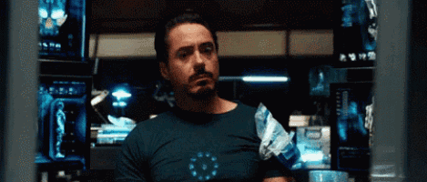 a man with a beard is wearing a t-shirt that says iron man