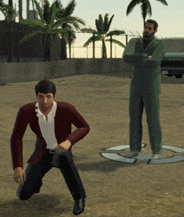 a man in a suit stands next to a man on the ground