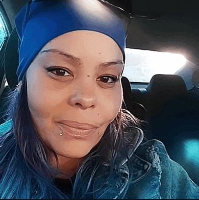 a woman in a car wearing a blue headband and a denim jacket