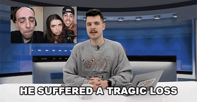 a man is sitting at a desk with the words he suffered a tragic loss