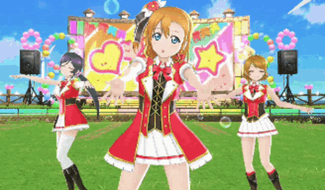 three anime girls are dancing in front of a stage with balloons and hearts on it