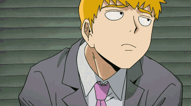 a man in a suit and tie is making a funny face